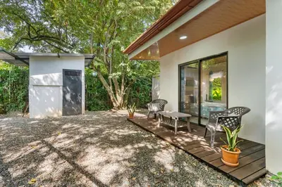 a patio of a house with chairs and a bench at Tropical Oasis with Casita — Minutes to Tamarindo in Villarreal