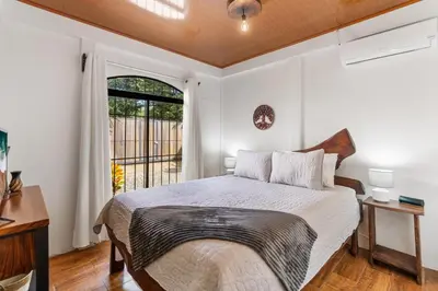 a bedroom with a large bed and a window at Tropical Oasis with Casita — Minutes to Tamarindo in Villarreal