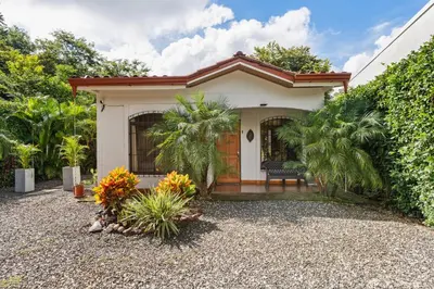 a small white house with a porch at Tropical Oasis with Casita — Minutes to Tamarindo in Villarreal