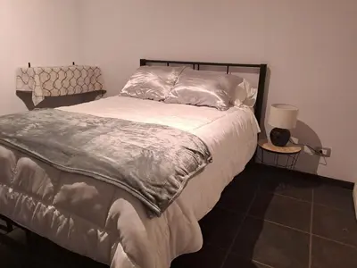 a bedroom with a bed and a lamp on a tiled floor at Costa Verde Retreat 1 - Ground Floor in Quepos