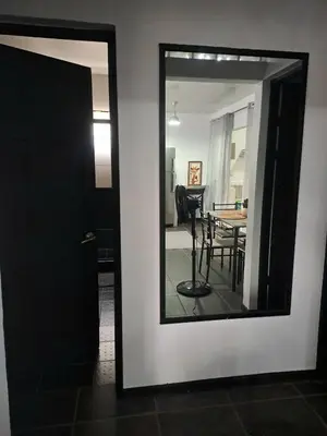 a mirror on a wall next to a dining room at Costa Verde Retreat 1 - Ground Floor in Quepos