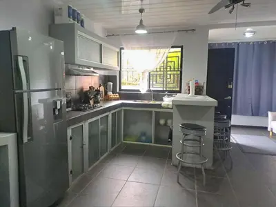 a kitchen with a stainless steel refrigerator and a counter at Costa Verde Retreat 1 - Ground Floor in Quepos