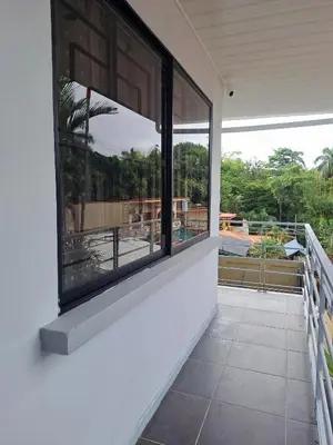 a balcony with windows and a view of a pool at Costa Verde Retreat 2 - Upper Floor in Quepos