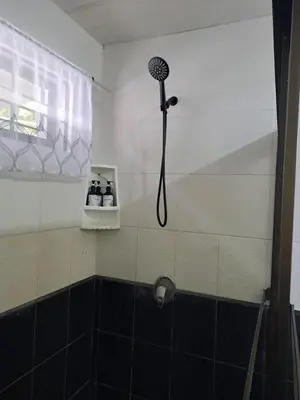 a shower with a shower head in a bathroom at Costa Verde Retreat 2 - Upper Floor in Quepos
