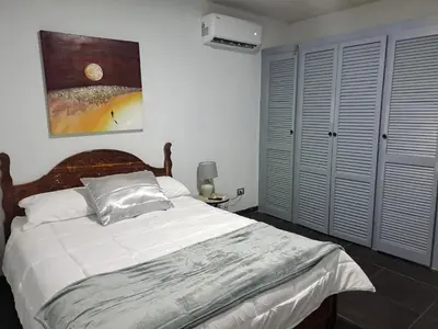 a bedroom with a large bed with white sheets at Costa Verde Retreat 2 - Upper Floor in Quepos