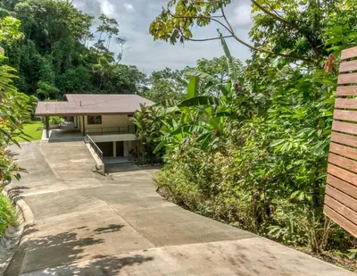 a walkway leading to a house in a garden at Villa Ballena-luxury Ocean view in Uvita