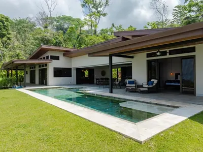 a house with a swimming pool in the yard at Villa Ballena-luxury Ocean view in Uvita