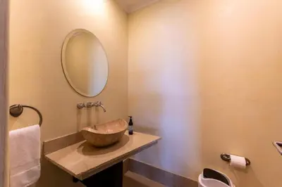 a bathroom with a bowl sink and a mirror at Malinche 422B- Ocean view condo at Reserva Conchal in Brasilito