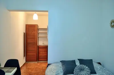 a bedroom with a bed with blue pillows at Habitación privada en La Sabana in San José