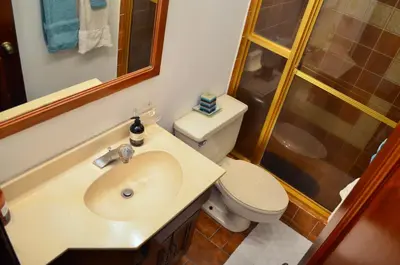 a bathroom with a toilet and a sink and a shower at Habitación privada en La Sabana in San José