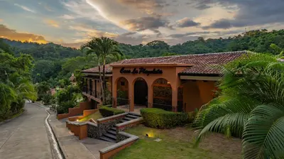 a building with a sign on the front of it at Casa Plazoleta 4 bdr private pool in Los Suenos in Herradura