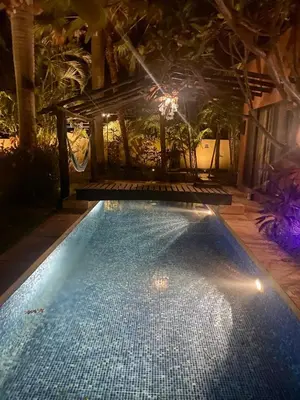 a large swimming pool with lights in a room at Casa Clancy in Tamarindo