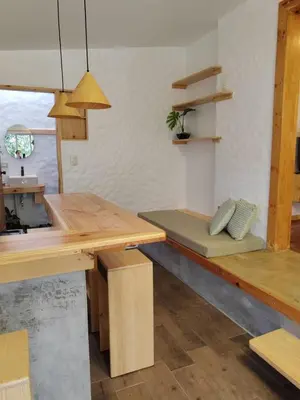 a room with a wooden table and a bench at Apartamento Agapanto, descanso, ocio o trabajo in La Asunción