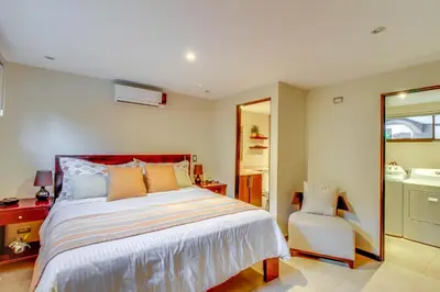 a bedroom with a large bed and a chair at The Cove 7/8 at Playa Ocotal in Ocotal