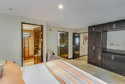 a bedroom with a bed and a flat screen tv at The Cove 7/8 at Playa Ocotal in Ocotal