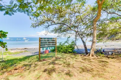 a sign on the side of a beach at The Cove 7/8 at Playa Ocotal in Ocotal