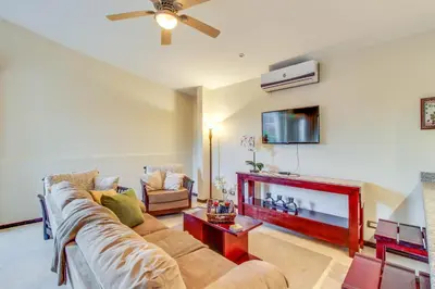 a living room with a couch and a tv at The Cove 7/8 at Playa Ocotal in Ocotal