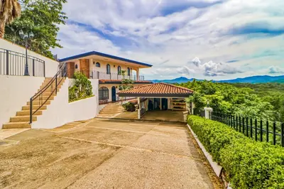 an image of a house with a fence at Casa Mimosa Buenavista in Playa Flamingo