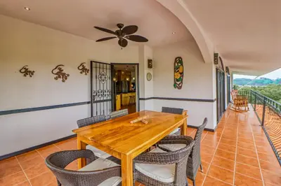 a dining room with a wooden table and chairs at Casa Mimosa Buenavista in Playa Flamingo