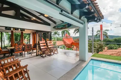 an outdoor patio with a pool and a table and chairs at Villa Sol 36 in Playa Hermosa