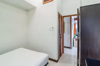 a bedroom with a bed and a wooden door at Villa Sol 36 in Playa Hermosa