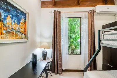 a bedroom with a desk and a window at Villa Sol 36 in Playa Hermosa