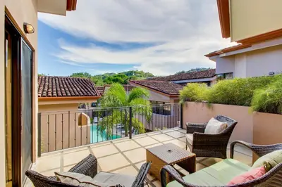 a patio with chairs and a table on a balcony at The Cove 5/6 at Playa Ocotal in Ocotal