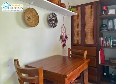 a wooden table and chair in a room at Cozy Apartment Downtown in Nicoya