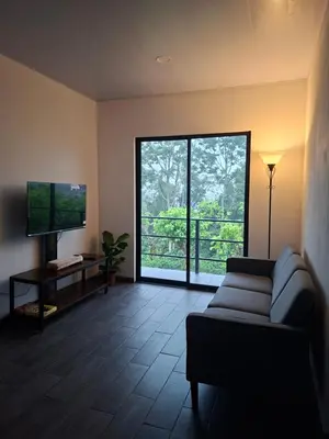 a living room with a couch and a large window at Villa Kaza Proyecto in Santa María