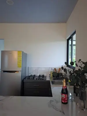 a kitchen with a refrigerator and a bottle of wine at Villa Kaza Proyecto in Santa María