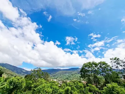a view of the mountains and trees under a cloudy sky at Villa Kaza Proyecto in Santa María
