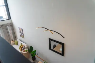a room with a white wall with some plants on it at Sakura Haus in Turrialba