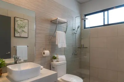 a bathroom with a sink and a toilet and a shower at Sakura Haus in Turrialba