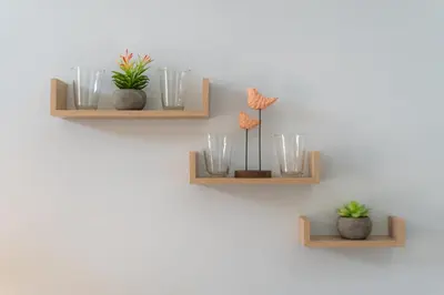 two wooden shelves with glasses and plants on a wall at Sakura Haus in Turrialba