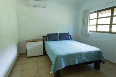 a small bedroom with a bed and a window at Tortuga HBH in Playa Hermosa