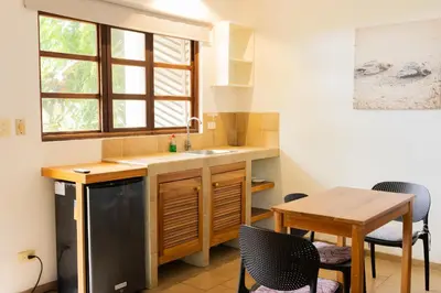 a kitchen with a sink and a table at Tortuga HBH in Playa Hermosa