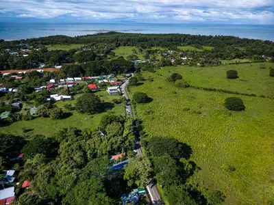 an aerial view of a small town in a field at Deer Apartments Bahía Ballena in Uvita