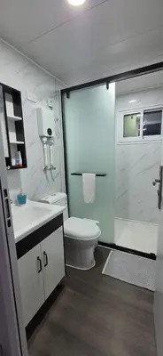a bathroom with a toilet and a glass shower at contenedor estudio in Tilarán