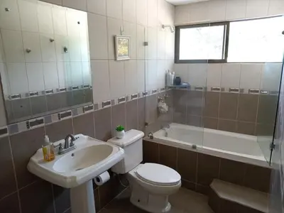 a bathroom with a toilet and a sink and a tub at Escazú 4BR- Full house premium location in San Rafael
