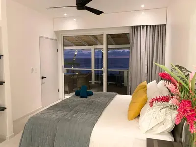a bedroom with a bed with a view of the ocean at Backyard Beach House Oceanfront Luxury 5 Bdr in Playa Hermosa