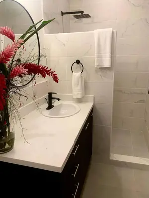 a white bathroom with a sink and a shower at Backyard Beach House Oceanfront Luxury 5 Bdr in Playa Hermosa