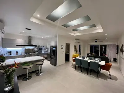 a kitchen and living room with a table and chairs at Backyard Beach House Oceanfront Luxury 5 Bdr in Playa Hermosa