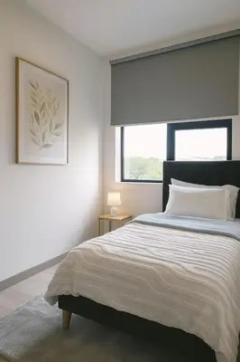 a bedroom with a large bed and a window at Modern Condo in Núcleo La Sabana with Pool in San José