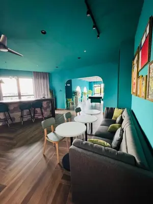 a living room with a couch and a table and chairs at Modern Condo in Núcleo La Sabana with Pool in San José