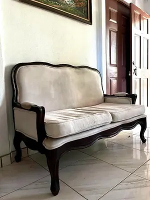 a couch sitting in a room next to a door at La Casa de Tita in Orotina