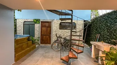 a staircase in front of a house with a bike at Olas del alba in Tapantí