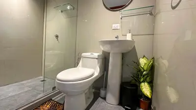 a bathroom with a toilet and a sink and a shower at Olas del alba in Tapantí