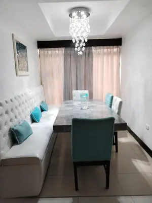 a dining room with a table and a chandelier at Casa en San José de la Montaña in Heredia