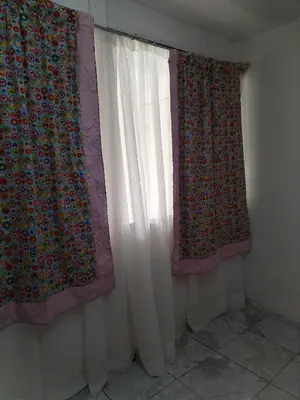 two curtains in a room next to a window at Casa en San José de la Montaña in Heredia
