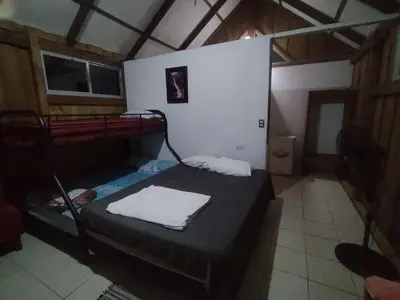 a small room with a bed in a house at La Ceiba Ecoadventures Wildlife Reserve in Platanillo